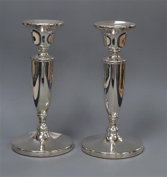 A pair of moder silver candlesticks, on circular bases 17cm.